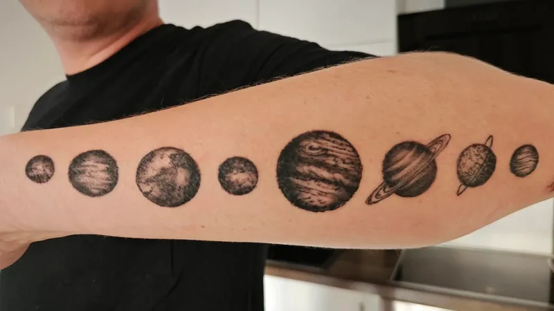 Planets tattoo on a forearm